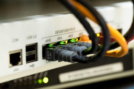 Back of a Fibre/wifi router with cables