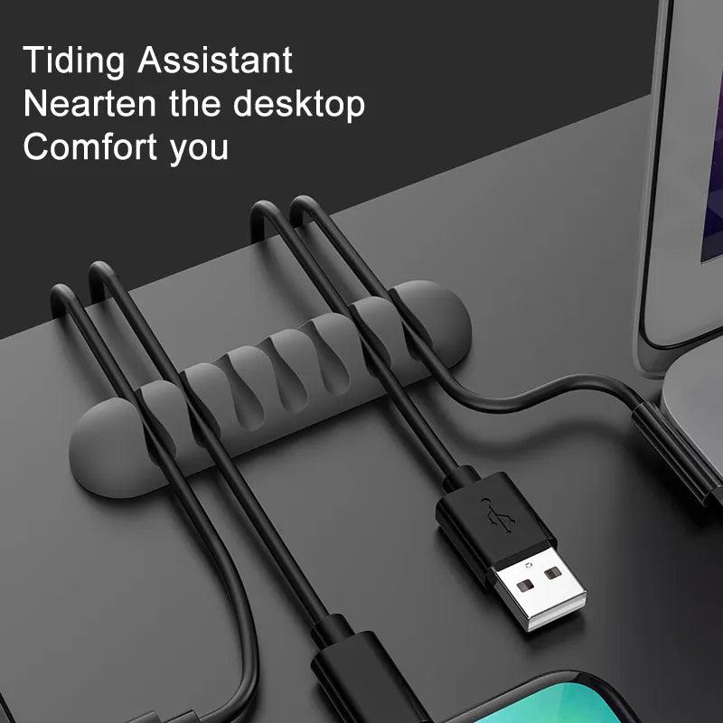 Smooth Design Silicone Cable Holder in Black on black desk with cables and laptop