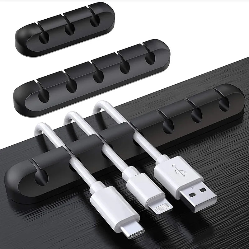 Scalloped Design Silicone Cable Organizer Black on back desk with cables