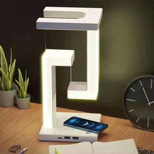 FTOYIN Suspending Anti-gravity Night Light 10W on desk with smart phone charging